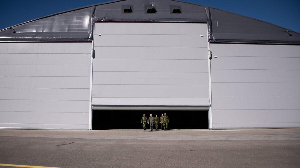 Aircraft hangar on an airfield, used for storing and maintaining planes.